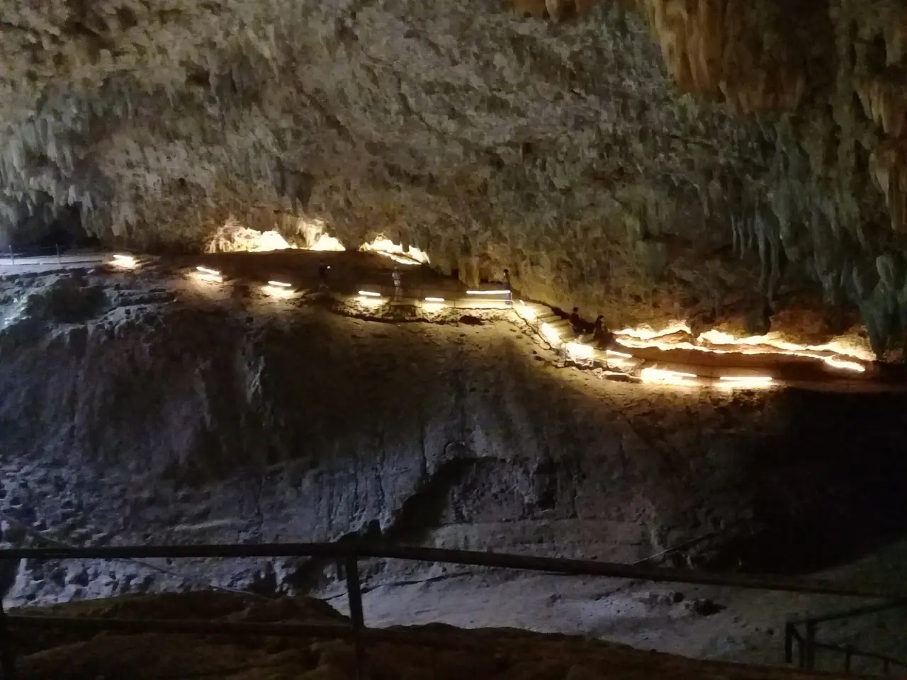 ทางเดินราวกั้นและแสงไฟเรียงตามผนังหินปูนภายในถ้ำหลวง ภาพจาก Wikimedia Commons ผู้ถ่าย Taweetham สัญญา CC BY-SA 4.0 ภาพชุดเดียวกันบางภาพถ่ายเมื่อ 20 ม.ค. 2566 แต่ภาพนี้ไม่ลงวันที่ในรายละเอียดที่เราอ่าน เป็นภาพประกอบและสภาพปัจจุบันอาจต่างไป